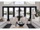 Beautiful living room with light-colored armchairs and view of pool and backyard at 5 E Oakwood Hills Dr, Chandler, AZ 85248