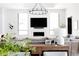 Elegant living room featuring a modern fireplace, large TV, and a stylish console table at 5 E Oakwood Hills Dr, Chandler, AZ 85248
