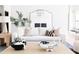 Close up of a stylish living room featuring a white sofa, modern coffee table, and elegant decorations at 5 E Oakwood Hills Dr, Chandler, AZ 85248