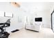 Versatile living space with modern exercise equipment, a comfortable sofa, and natural light, perfect for active and relaxed living at 5 E Oakwood Hills Dr, Chandler, AZ 85248