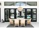 Inviting outdoor dining space features a modern table, six chairs, and a stylish hanging pendant light at 5 E Oakwood Hills Dr, Chandler, AZ 85248