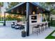 Delightful outdoor kitchen with a full bar, seating area, and built-in grill at 5 E Oakwood Hills Dr, Chandler, AZ 85248