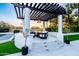 Outdoor lounge featuring a pergola, cozy seating, a fire pit, and sunset views amid lush greenery at 5 E Oakwood Hills Dr, Chandler, AZ 85248