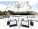 Stylish patio with elegant chairs, a small table, and a charming umbrella, perfect for relaxing and enjoying the outdoors at 5 E Oakwood Hills Dr, Chandler, AZ 85248