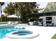 Resort-style pool area with a spa, lounge chairs, and an outdoor kitchen, perfect for luxurious outdoor living at 5 E Oakwood Hills Dr, Chandler, AZ 85248