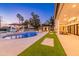 Backyard oasis featuring a pool, spa, covered lounge, outdoor dining, pristine landscaping, and ample seating at 5 E Oakwood Hills Dr, Chandler, AZ 85248