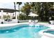 Beautiful pool area with comfortable lounge chairs and a pergola-covered dining area, ideal for outdoor relaxation and gatherings at 5 E Oakwood Hills Dr, Chandler, AZ 85248