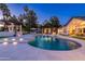 Stunning pool area with an illuminated pool, spa, comfortable seating, a pergola, and beautiful landscaping at 5 E Oakwood Hills Dr, Chandler, AZ 85248