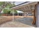 Expansive backyard featuring a covered patio with an adjacent wooden privacy fence and landscaping at 512 N Ironwood --, Mesa, AZ 85201
