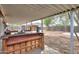 Spacious backyard featuring covered patio with bar, seating, landscaping, and shed at 512 N Ironwood --, Mesa, AZ 85201