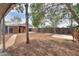 Wide open backyard featuring a shed, trees and a patio area, fenced in with a wooden fence at 512 N Ironwood --, Mesa, AZ 85201