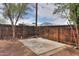 Cozy backyard patio featuring a gravel perimeter, wooden fence, and mature shade trees at 512 N Ironwood --, Mesa, AZ 85201
