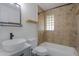 Updated bathroom features a modern sink, stylish tile, and a shower with a decorative window at 512 N Ironwood --, Mesa, AZ 85201