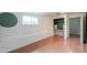 A well-lit bedroom with built-in shelving, wood floors, and a view to another room at 512 N Ironwood --, Mesa, AZ 85201