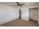Bright bedroom with carpet, ceiling fan, adjacent closet and open entry to another room at 512 N Ironwood --, Mesa, AZ 85201