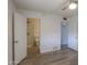 Bright bedroom featuring wood floors, ceiling fan and view to a bathroom and another room at 512 N Ironwood --, Mesa, AZ 85201