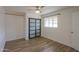 Well-lit bedroom features modern sliding closet doors and light wood-look flooring at 512 N Ironwood --, Mesa, AZ 85201