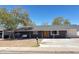 Charming single-story home with a welcoming yellow front door and swing on the front porch at 512 N Ironwood --, Mesa, AZ 85201