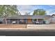 Charming single-story home featuring a cozy front porch with hanging swing and modern outdoor seating at 512 N Ironwood --, Mesa, AZ 85201