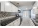 A view of the kitchen featuring stainless steel appliances, tile countertops, and a connecting dining area at 512 N Ironwood --, Mesa, AZ 85201
