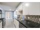 Spacious kitchen featuring stainless steel appliances, double sinks, breakfast bar and access to another room at 512 N Ironwood --, Mesa, AZ 85201