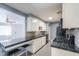 A functional kitchen with black countertops, mosaic backsplash, white cabinets and a breakfast bar at 512 N Ironwood --, Mesa, AZ 85201