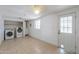 Bright laundry room with washer, dryer, tile flooring and a white painted brick wall at 512 N Ironwood --, Mesa, AZ 85201