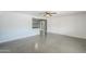 Bright living room featuring polished concrete floors, ceiling fan, and a breakfast bar that opens to the kitchen at 512 N Ironwood --, Mesa, AZ 85201