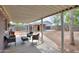 Covered outdoor patio featuring multiple seating areas and view of landscaped backyard at 512 N Ironwood --, Mesa, AZ 85201