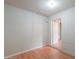 Room with painted brick walls, light-colored hardwood floors, and an open door to another room at 512 N Ironwood --, Mesa, AZ 85201