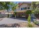 Exterior of the home with covered patio overlooking the backyard space and low maintenance landscape at 533 N Cobblestone St, Gilbert, AZ 85234