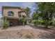 Landscaped backyard showing mature shade trees, covered patio, and the home's exterior at 533 N Cobblestone St, Gilbert, AZ 85234
