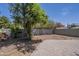 The backyard includes a patio, shade trees, a partial garden, and a neutral-colored fence at 533 N Cobblestone St, Gilbert, AZ 85234