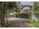 Lush backyard featuring a covered patio, mature trees, and attractive landscaping at 533 N Cobblestone St, Gilbert, AZ 85234