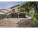 Exterior view of the home's backyard features a covered patio and well-maintained landscaping at 533 N Cobblestone St, Gilbert, AZ 85234