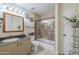 Well-lit bathroom with tub-shower, single sink vanity, and neutral tile flooring at 533 N Cobblestone St, Gilbert, AZ 85234