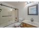 A bathroom features a shower and tub combination with a framed mirror, and a matching vanity at 533 N Cobblestone St, Gilbert, AZ 85234