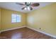 Bedroom featuring beautiful wood floors and ample natural light at 533 N Cobblestone St, Gilbert, AZ 85234