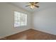 A simple bedroom features a ceiling fan and one window offering natural light and outside views at 533 N Cobblestone St, Gilbert, AZ 85234
