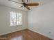 A simple bedroom features a ceiling fan and one window offering natural light and outside views at 533 N Cobblestone St, Gilbert, AZ 85234