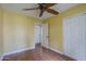 Bedroom featuring laminate flooring, a ceiling fan, and closet with sliding doors at 533 N Cobblestone St, Gilbert, AZ 85234