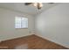 Cozy bedroom with hardwood floors, a window providing natural light and neutral wall paint at 533 N Cobblestone St, Gilbert, AZ 85234