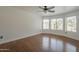 A bright bedroom offers multiple windows with outside views and wood floors at 533 N Cobblestone St, Gilbert, AZ 85234