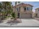 Charming home with desert landscaping, mature trees, and a two-car garage with a red tile roof at 533 N Cobblestone St, Gilbert, AZ 85234