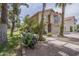 Charming two-story home featuring desert landscaping, mature trees, and a red tile roof at 533 N Cobblestone St, Gilbert, AZ 85234