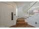 Entryway featuring hardwood floors, a staircase, and a white front door at 533 N Cobblestone St, Gilbert, AZ 85234