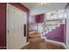 Welcoming foyer with hardwood floors, a staircase with white railing, and a modern light fixture at 533 N Cobblestone St, Gilbert, AZ 85234