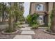 Beautifully landscaped front yard with stone pavers, mature trees, and lush green vines on the house at 533 N Cobblestone St, Gilbert, AZ 85234