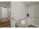 Upstairs hallway featuring hardwood floors, a light fixture and stairs leading to the first floor at 533 N Cobblestone St, Gilbert, AZ 85234
