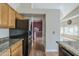 Kitchen featuring granite countertops, oak cabinets, and black appliances at 533 N Cobblestone St, Gilbert, AZ 85234